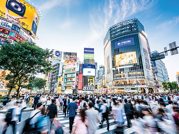 People walking across a crossroads in Japan